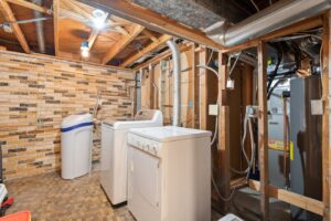 tankless water heater mounted on wall in clean utility room