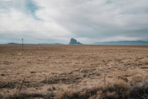 Dry New Mexico desert landscape transforming under monsoon rain clouds